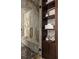 Walk-in shower with marble walls, a built-in bench, and a dark wood shelving unit at 4900 59Th S Ave, St Petersburg, FL 33715