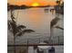 Waterfront sunset view from a balcony with patio seating and palm trees at 4900 59Th S Ave, St Petersburg, FL 33715