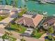 Aerial view showcases a beautiful home with a terracotta roof, a screened pool, and waterfront access at 4930 60Th S Ave, St Petersburg, FL 33715