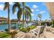 Waterfront backyard with well manicured landscaping, a boat dock, and relaxing seating at 4930 60Th S Ave, St Petersburg, FL 33715