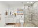 Modern bathroom with glass shower, stone tile, floating vanity, and beach-themed art at 4930 60Th S Ave, St Petersburg, FL 33715