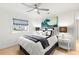 Cozy bedroom with a ceiling fan, light wood floors, and a window providing natural light at 4930 60Th S Ave, St Petersburg, FL 33715