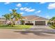 Beautiful single-story home with a tile roof, manicured lawn, and mature palm trees at 4930 60Th S Ave, St Petersburg, FL 33715