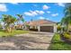 Beautiful single-story home featuring a tile roof, brick driveway, and a lush tropical landscaped front yard at 4930 60Th S Ave, St Petersburg, FL 33715