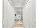 Hallway with three closets leading to bathroom featuring stylish finishes and tile shower at 4930 60Th S Ave, St Petersburg, FL 33715