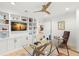 Bright home office with hardwood floors, built-in shelving, and a modern glass desk at 4930 60Th S Ave, St Petersburg, FL 33715