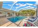 Refreshing pool surrounded by a screened lanai, comfortable lounge chairs and lush landscaping at 4930 60Th S Ave, St Petersburg, FL 33715