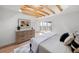 Light-filled bedroom with exposed beams, dresser, and a sliding door to a balcony at 5011 S Elberon St, Tampa, FL 33611