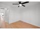 Bright bedroom boasts hardwood floors, a modern ceiling fan, and neutral decor at 5011 S Elberon St, Tampa, FL 33611