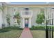 Charming facade featuring a brick walkway, blue door, white pillars, and a balcony at 5011 S Elberon St, Tampa, FL 33611