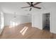 Spacious living room with hardwood floors featuring a ceiling fan and an ensuite bath at 5011 S Elberon St, Tampa, FL 33611