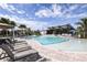 Enjoy the community's resort-style pool, surrounded by lush landscaping and comfortable lounge chairs under a bright blue sky at 5021 124Th E Ave, Parrish, FL 34219