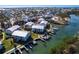 Aerial view shows a well-maintained waterfront condo community with boat docks and water access at 522 Pine Ave # 6A, Anna Maria, FL 34216