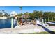 Waterfront home boasts a private dock with seating and a boat, perfect for enjoying the coastal lifestyle at 522 Pine Ave # 6A, Anna Maria, FL 34216