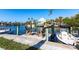 Waterfront home boasts a private dock with seating and a boat, perfect for enjoying the coastal lifestyle at 522 Pine Ave # 6A, Anna Maria, FL 34216