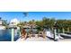 Charming waterfront homes with a private dock, boat, and inviting wooden chairs at 522 Pine Ave # 6A, Anna Maria, FL 34216