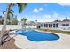 Backyard featuring an in-ground pool, privacy fence, tropical landscaping, and covered patio at 5926 Bayou Grande Ne Blvd, St Petersburg, FL 33703