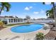 Backyard featuring an in-ground pool, privacy fence, tropical landscaping, and covered patio at 5926 Bayou Grande Ne Blvd, St Petersburg, FL 33703