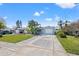 Charming single-story home featuring a well-manicured lawn and a long driveway with parking for two cars at 5926 Bayou Grande Ne Blvd, St Petersburg, FL 33703