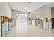 Open-concept room with tile floors and modern lighting, adjoining the kitchen, currently undergoing renovations at 5926 Bayou Grande Ne Blvd, St Petersburg, FL 33703