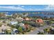 Aerial view of a neighborhood with waterfront homes, lush greenery, and mature trees at 601 Cordova Ne Blvd, St Petersburg, FL 33704