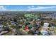 Aerial view of a home in a waterfront community with lush trees, and a golf course in the background at 601 Cordova Ne Blvd, St Petersburg, FL 33704