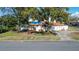 Charming single-story home featuring a vibrant orange tile roof, lawn, and driveway at 601 Cordova Ne Blvd, St Petersburg, FL 33704