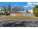 A single-story house featuring a vibrant orange tile roof and white fence at 601 Cordova Ne Blvd, St Petersburg, FL 33704