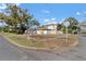 Charming single-story home with a red tile roof, a white fence, and mature trees on a corner lot at 601 Cordova Ne Blvd, St Petersburg, FL 33704