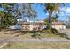 Charming single-story home featuring a vibrant orange tile roof and a well-maintained lawn at 601 Cordova Ne Blvd, St Petersburg, FL 33704