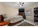 Bedroom features a bed, dark rug, neutral paint, ceiling fan, and tile flooring at 6104 Dory Way, Tampa, FL 33615