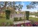 The Bayport community sign is surrounded by landscaping and colorful flowers near the lake at 6104 Dory Way, Tampa, FL 33615