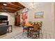 Bright dining area with wood-beam ceiling, decorative chandelier, and stylish table with chairs at 6104 Dory Way, Tampa, FL 33615