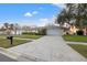 Charming home exterior with a wide driveway, a two-car garage, and manicured landscaping at 6104 Dory Way, Tampa, FL 33615