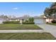 Charming single-story home with manicured lawn and stone accents on the facade at 6104 Dory Way, Tampa, FL 33615