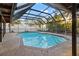 Screened-in swimming pool, with lounge chairs and a well-maintained deck at 6104 Dory Way, Tampa, FL 33615