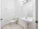 All white half bathroom featuring a tile floor and pedestal sink at 615 Olive Tree Ct, Clearwater, FL 33756