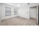 Bedroom with neutral carpet, ceiling fan, and two windows at 615 Olive Tree Ct, Clearwater, FL 33756