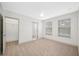 Bedroom with neutral carpet, ceiling fan, walk-in closet, and en suite bathroom at 615 Olive Tree Ct, Clearwater, FL 33756