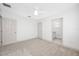 A bright bedroom features neutral walls, carpet, ceiling fan, and en suite bathroom at 615 Olive Tree Ct, Clearwater, FL 33756