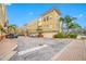 Exterior view of a tan three-story townhome featuring attached garages and a tile roof at 615 Olive Tree Ct, Clearwater, FL 33756