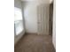 Small carpeted room with a bright window and a closet at 615 Olive Tree Ct, Clearwater, FL 33756