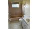 Bathroom with a tub, toilet, vanity and peach ceramic tiles at 6188 Pinehurst Dr, Spring Hill, FL 34606