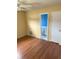 Bedroom with yellow walls and wood floor at 6188 Pinehurst Dr, Spring Hill, FL 34606