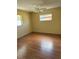 Bedroom with wood floor and two windows at 6188 Pinehurst Dr, Spring Hill, FL 34606