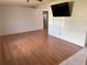 Living room featuring wood floors and a ceiling fan at 6188 Pinehurst Dr, Spring Hill, FL 34606