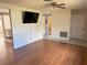 Living room with wood floors and a mounted tv at 6188 Pinehurst Dr, Spring Hill, FL 34606