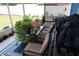 Enclosed porch with an outdoor seating area and lots of plants at 6188 Pinehurst Dr, Spring Hill, FL 34606