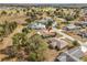 An aerial view of a house and the surrounding neighborhood. The house has a brown roof at 7078 Lexington Cir, Brooksville, FL 34602