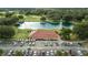 Stunning aerial view of a golf course community clubhouse with a lake and lush greenery at 7078 Lexington Cir, Brooksville, FL 34602